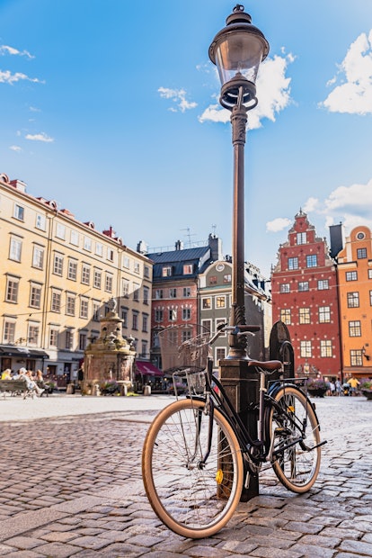 Bicycle leaning against a lamppost in Stockholm Gamla Stan. Bike parked in a cobbled square in Stock...